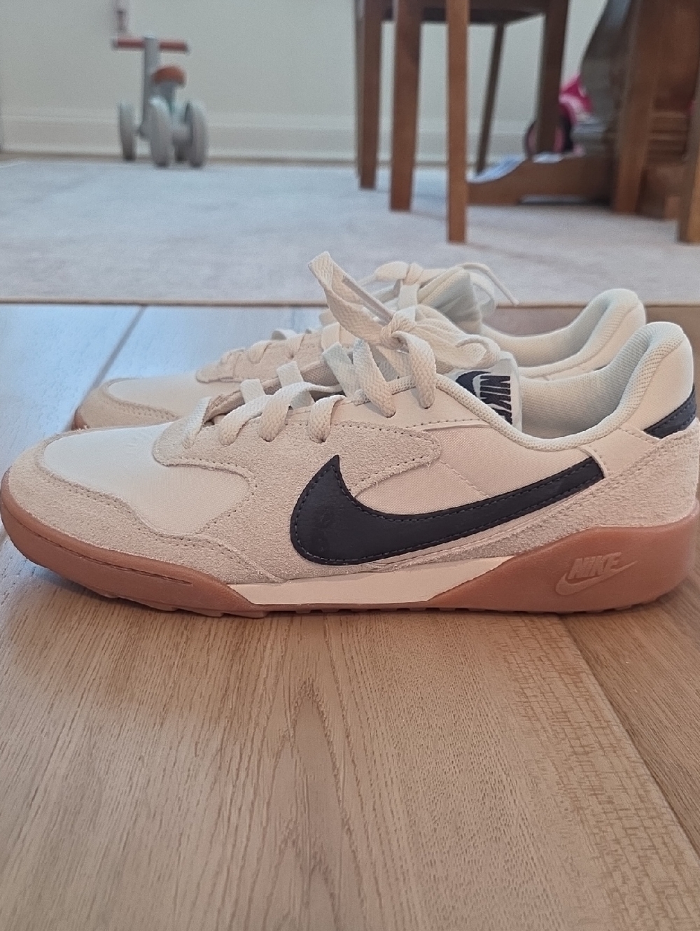 Nike Cream Sneakers with Black Swoosh and Gum Sole